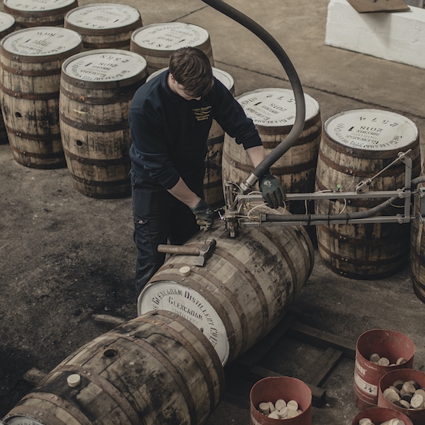 A worker fills casks at Glencadam Distillery.